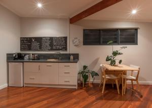 a kitchen with a table and a chalkboard on the wall at Salt The Studio in Kalbarri