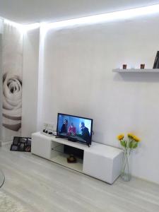 a living room with a tv on a white wall at Apartment Silvi in Varna City