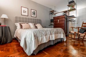 a bedroom with a bed and a wooden floor at 1910 B&B in Bari