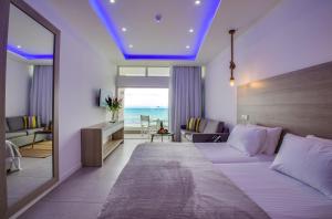 a hotel room with a bed and a view of the ocean at Island Boutique Hotel in Larnaca