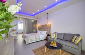 a living room with a couch and a bed at Island Boutique Hotel in Larnaca