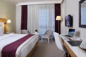 Postel nebo postele na pokoji v ubytování Masel Hotel
