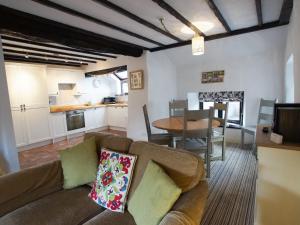 a living room and kitchen with a couch and a table at Laurel Cottage in Ulverston