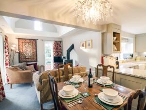 a kitchen and living room with a table and chairs at South Lodge in Sturminster Newton