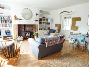 a living room with a couch and a fireplace at Corner Cottage in Amble
