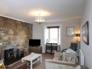 a living room with a couch and a fireplace at Seascape in Lossiemouth