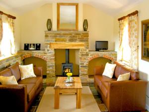 a living room with two couches and a fireplace at Valley View in Ross on Wye