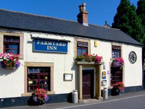 a white building with flowers on the front of it at River Cottage in Bakewell +2 photos