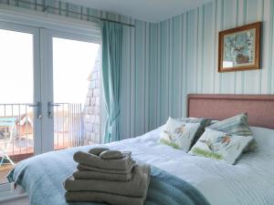 a bedroom with a bed with towels on it at Seascape in Lossiemouth