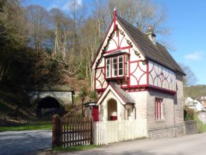 a small house in front of a tunnel at The Gate House in Oakamoor