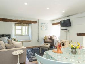 ein Wohnzimmer mit einem Sofa und einem Tisch in der Unterkunft Mill Cottage in Tenbury