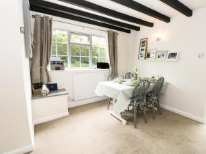 a dining room with a table and chairs and a window at Cobble Cottage in Hornsea