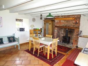 a dining room with a table and a fireplace at The Lookout in Tweedmouth