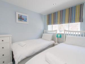 a bedroom with two beds and a window at Bayview in Brixham