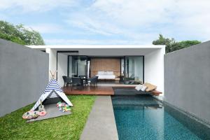 a house with a swimming pool and a bedroom at Origin Ubud in Ubud