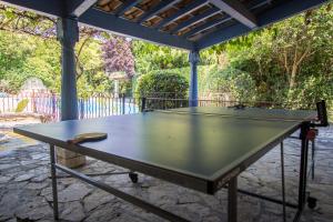 a ping pong table sitting under a gazebo at Mas de Shogol in Cavaillon