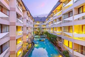an aerial view of an apartment building with a swimming pool at Episode Kuta Bali in Kuta