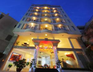 a large building with christmas decorations in front of it at Kim Yen Hotel in Ho Chi Minh City
