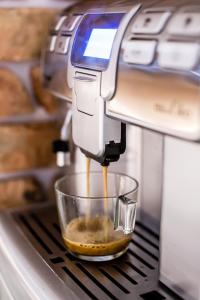 a mixer is making food in a glass bowl at Meet Poznań Hotel in Poznań