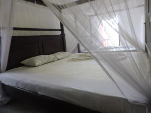Postel nebo postele na pokoji v ubytování Asantha Guest House