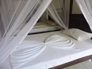 Postel nebo postele na pokoji v ubytování Asantha Guest House