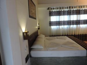 Postel nebo postele na pokoji v ubytování Asantha Guest House