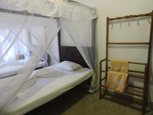 Postel nebo postele na pokoji v ubytování Asantha Guest House