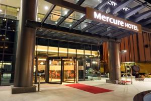 a nighttime view of a metroisse hotel with a sign on it at Mercure Tetovo in Tetovo