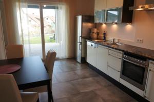 a kitchen with a table and a refrigerator and a sink at Ferienwohnung Familie Nachtmann in Beilngries