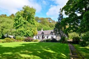 a house with a large yard with green grass at The Lagg in Lagg
