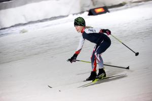 a woman is skiing down a snow covered slope at Sport & Spa Hotel Vesileppis in Leppävirta