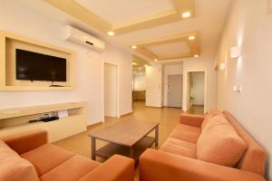 a living room with a couch and a table at Royal Apartment on The Central Beach in Netanya in Netanya