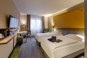 Ένα ή περισσότερα κρεβάτια σε δωμάτιο στο Mercure Stuttgart Zuffenhausen +46 φωτογραφίες