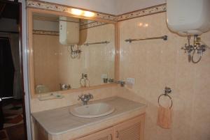 a bathroom with a sink and a mirror at Colonial 4 B/R Home, Great for Families, Coonoor in Coonoor +55 photos