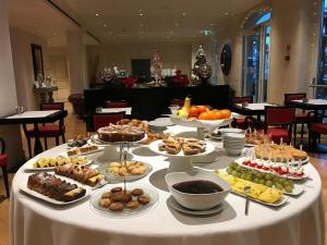 a table with many different types of food on it at Siri Hotel in Fano