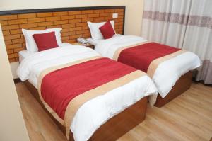 Letto o letti in una camera di Hotel Bagmati