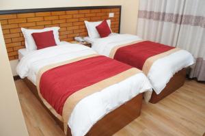 A bed or beds in a room at Hotel Bagmati