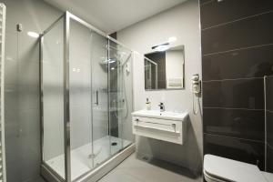 a bathroom with a shower and a sink and a toilet at Hotel Jana in Međugorje +35 photos