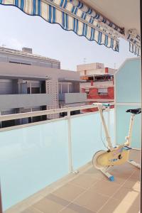 a room with a treadmill in front of a building at Apartamento Blanc Mar in Peniscola