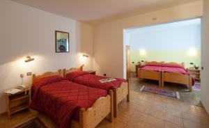 Ένα ή περισσότερα κρεβάτια σε δωμάτιο στο Hotel Genzianella