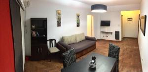 a living room with a couch and a table at San Isidro Flat in San Isidro