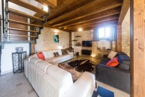 a living room with two couches and a television at Le Tre Giare in Modica