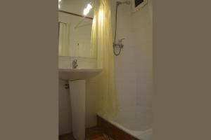 a bathroom with a sink and a shower and a tub at Ribeira Brava Studio Sea View in Ribeira Brava