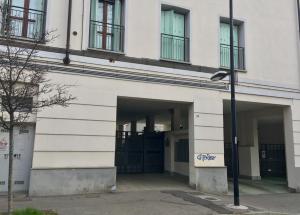 a building with two garage doors and a street light at Monolocale vicino Milano CIR 00014 in Lodi
