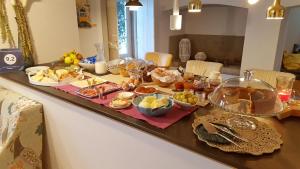a kitchen counter filled with dishes and plates of food at Águamel Sintra, Boutique Guest House in Sintra