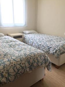 a bedroom with two beds and a window at Casa Toboso 2 in Torre del Mar +37 photos