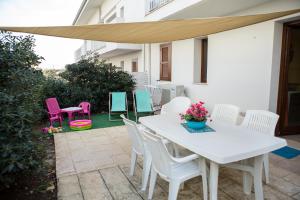 a white table and chairs on a patio at Profumo di Mare in Punta Secca