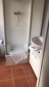 a bathroom with a shower and a sink at Waldhotel Zollhaus in Nuremberg