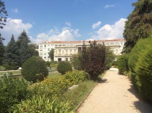 a large white building with a garden in front of it at Les Grands Cedres D3 in Nice
