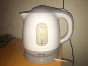 a white electric kettle with a remote control on it at L'angolo antico in Oristano